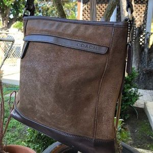 Brown unisex messenger Coach bag.